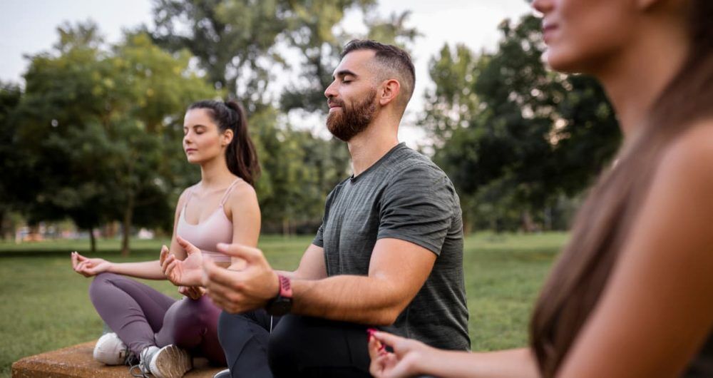 People meditating in park