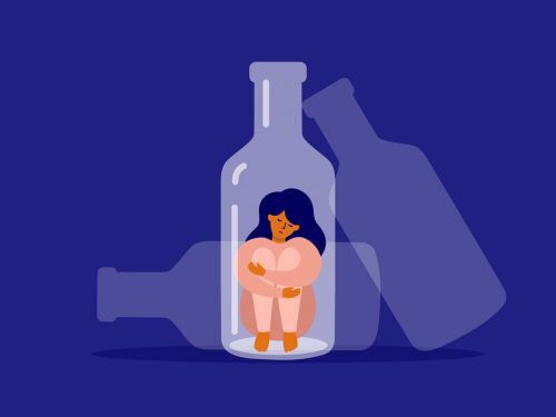 Unhappy woman sitting at bottle bottom hugging her knees.