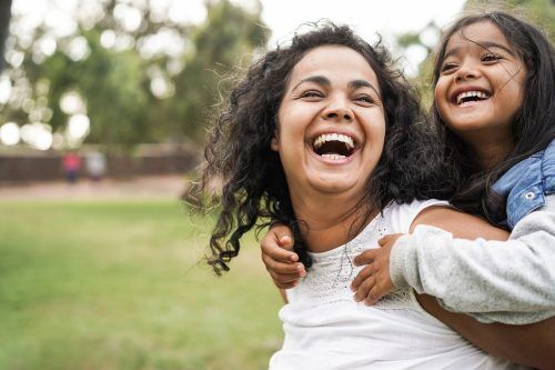 What to Expect After One Year Sober - happy mother having fun with her daughter outdoors.