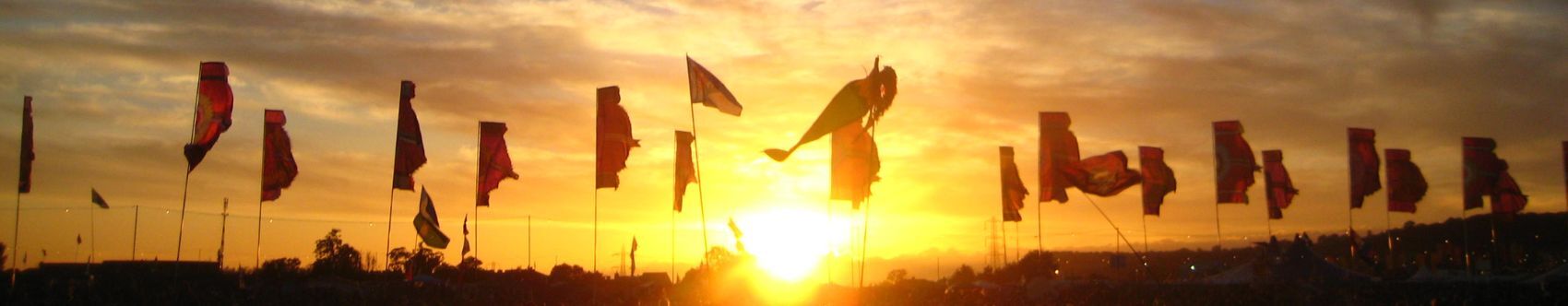 sunset view of flags at drug and alcohol glastonbury somerset